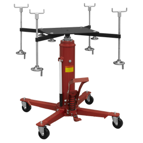 A Sealey Subframe Cradle and 800kg Transmission Jack Combo (SFC800COMBO) in red, featuring an adjustable mount and four highly maneuverable caster wheels. Additional attachment components are displayed in the background.