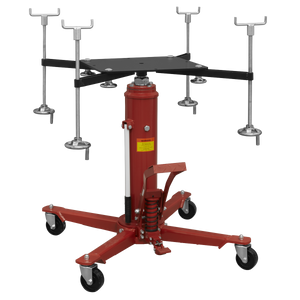 A Sealey Subframe Cradle and 800kg Transmission Jack Combo (SFC800COMBO) in red, featuring an adjustable mount and four highly maneuverable caster wheels. Additional attachment components are displayed in the background.