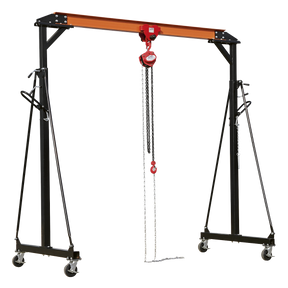 Introducing the Sealey Portable Lifting Gantry Crane Adjustable 1 Tonne & Hoist Combo - SG1000KIT, a height-adjustable gantry crane with a hoist assembly. This versatile equipment features a black and orange frame mounted on caster wheels for effortless mobility and includes chains that hang from the chain block to lift heavy objects up to 1000kg.