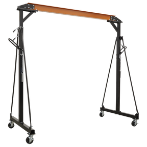 The Sealey Portable Lifting Gantry Crane Adjustable 1 Tonne - SG1000 boasts a black metal frame with a sturdy steel construction, an orange beam, and four caster wheels. It also features height-adjustable settings and stabilizing support arms.