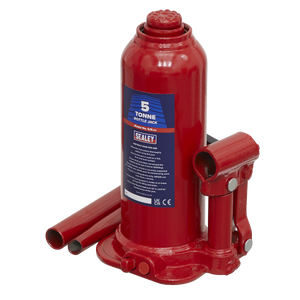 A red Sealey Bottle Jack 5 Tonne - SJ5 with a 2-piece handle and detached parts, designed for lifting heavy objects, featuring an overload valve for added safety.