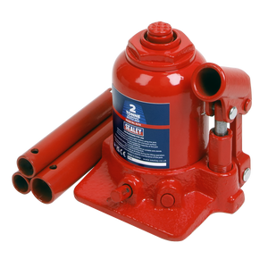 Image of a red Sealey Bottle Jack 2 Tonne Telescopic - SJT2 with dual-stage rams and a labeled capacity of 2 tonnes, alongside three cylindrical extension rods placed beside it. An overload valve ensures safety during operation.