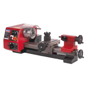 The Sealey Metalworking Mini Lathe 250mm - SM2503A is a red and black bench-mounted miniature lathe machine featuring various adjustment knobs, a high-torque motor, variable speed control, and a clear protective shield.