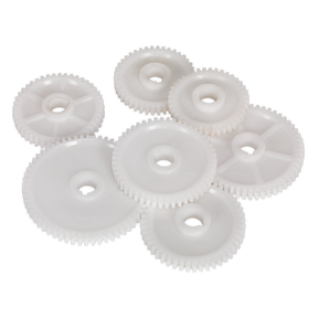Several white plastic gears of varying sizes, resembling the high-quality Sealey Thread Cutting Gear Kit Metric - SM2503TCK for a mini lathe, are arranged in a cluster on a plain background.
