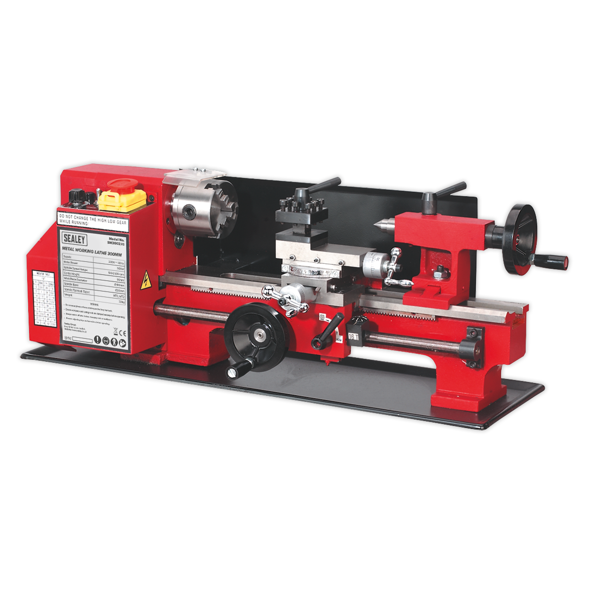 The Sealey Metalworking Lathe 300mm Between Centres - SM3002 features a red and black design, equipped with a powerful 300W motor, various adjustment knobs, a chuck for holding workpieces, and a motor housing labeled with the Sealey brand.