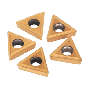 Five triangular carbide inserts from Sealey, Model SM3025CS1, featuring a central circular hole, are arranged in a scattered pattern. These Tips for Lathe Turning Tool Set SM3025CS1 - SM3025CS1R are ideal for steel lathe turning tool applications.