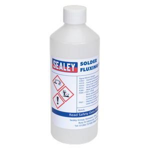 A 500ml plastic bottle labeled "Solder Fluxing Fluid 500ml Bottle - SOLFLUX" from the brand Sealey, featuring hazard symbols indicating health and safety warnings. The bottle contains liquid flux used for soldering purposes.