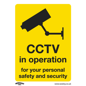 The "Warning Safety Sign - CCTV" by Sealey features a yellow background with a black image of a CCTV camera and text stating "CCTV in operation for your personal safety and security." Ideal for commercial environments, this sign is available in rigid plastic or other durable materials suitable for office use. This product comes as a pack of 10 (SS40P10).