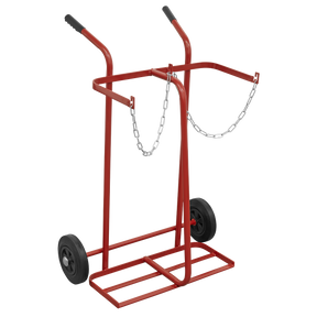 The Sealey Welding Bottle Trolley - 2 Bottle - ST28/B is a red metal cylinder cart featuring large wheels, a supporting platform, two handles, and a securing chain, designed specifically for transporting heavy cylinders. Its lightweight tubular steel frame ensures ease of movement.