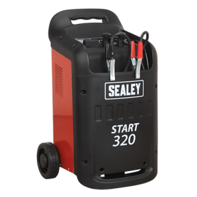 A red and black Sealey Starter/Charger 320/45Amp 12/24V 230V (model START320) with attached alligator clips, two wheels at the base, and a handle on top for portability; perfect for professional garages dealing with light commercial vehicles.