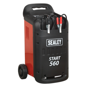 The Sealey START560 Starter/Charger 560/95A 12/24V 230V, a heavy-duty red and black battery starter/charger, perfect for professional garages with its wheels and handle, features attached jumper cables ideal for battery recovery.