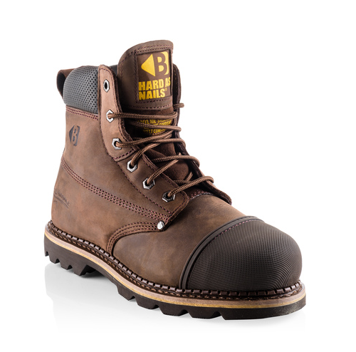 The "Buckler - Safety Steel Toe & Midsole - B301Sm" is a brown leather work boot featuring a reinforced toe, black outsole, and metal eyelets for laces. It sports a yellow "Hard As Nails" logo on the tongue and offers a classic safety footwear design with anti-penetration midsoles.