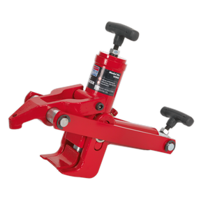 The Sealey Hydraulic Bead Breaker - TC966 is a red mechanical tool with two handles and a clamp-like mechanism, efficiently designed for breaking beads on commercial tyres, likely used for automotive or industrial applications.