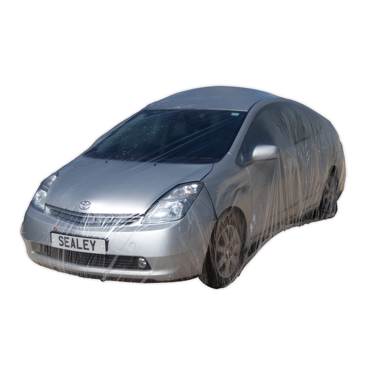 A silver car is wrapped in the Sealey Temporary Universal Car Cover Medium - TDCCM, showcasing effective vehicle protection, with a license plate that reads "SEALEY.