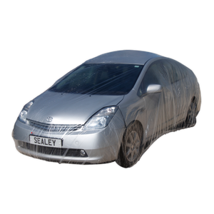 A silver car is wrapped in the Sealey Temporary Universal Car Cover Medium - TDCCM, showcasing effective vehicle protection, with a license plate that reads "SEALEY.