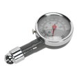 The Sealey Dial Type Pressure Gauge (model TSTPG43) is a silver analog tire pressure gauge with a round dial displaying measurements from 0 to 100psi, featuring a red indicator needle and a sturdy valve connector.