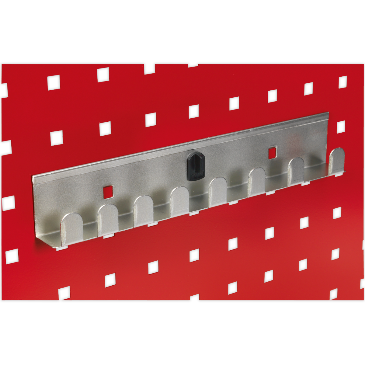 The Sealey Socket Holder 270mm - Capacity 8 x 1/2"Sq Drive - TTS35, featuring a sleek metallic design with eight slots, set against a vibrant red background adorned with a pattern of small black and white squares, perfectly complements the PerfoWall panels, providing seamless organization for your accessories.