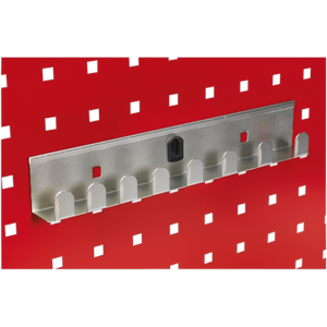 The Sealey Socket Holder 270mm - Capacity 8 x 1/2"Sq Drive - TTS35, featuring a sleek metallic design with eight slots, set against a vibrant red background adorned with a pattern of small black and white squares, perfectly complements the PerfoWall panels, providing seamless organization for your accessories.