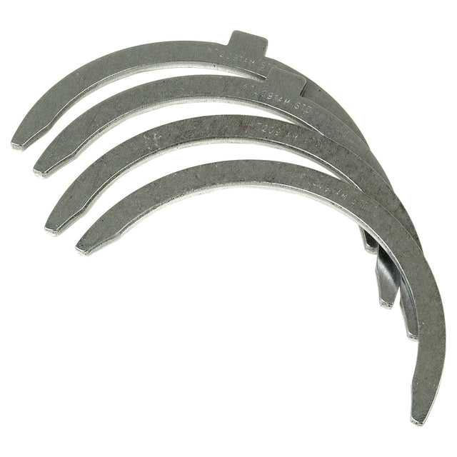 A Thrust Bearings Set of four curved metal washers arranged in a stack on a white background, suitable for Allis Chalmers tractors and available via Sparex, Part No. S.40343.