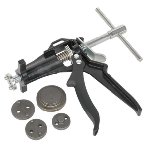 Displayed on a white background, a Sealey Brake Piston Wind-Back Tool Kit 5pc (VS0211) is showcased next to various circular metal components.