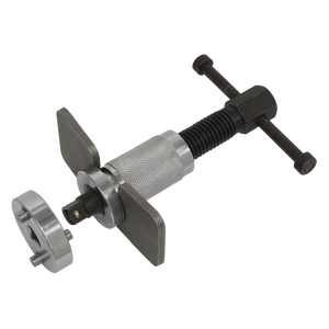 The Sealey Brake Piston Wind-Back Tool with Double Adaptor - VS024, featuring a T-shaped handle, adjustment screw, and attached piston wind-back adapter, is essential for working on rear brake calipers when installing new brake pads.