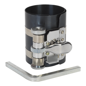 A Sealey Piston Ring Compressor 75mm Ø60-125mm, model VS155, featuring a black sprung steel wrap and a metallic adjustment mechanism, accompanied by a steel key.
