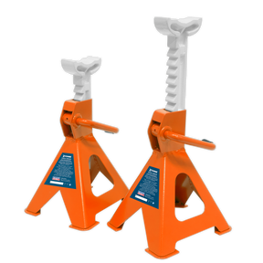 The Sealey Axle Stands (Pair) with a 2-tonne capacity per stand, model VS2002OR, are orange and white metal jack stands designed for vehicle lifting and support. They feature a ratchet-type axle stand for easy height adjustment and labeled safety instructions on their cast iron support posts.