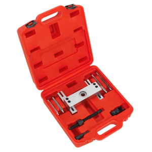 The Sealey Diesel Injector Puller VS2075 for BMW M47/M57 engines comes in a red plastic carrying case with compartments, containing a metal puller tool and several smaller tool components, specifically designed for removing diesel fuel injectors.