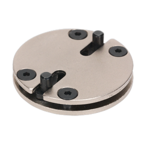 The Sealey Adjustable Brake Wind-Back Adaptor - 2-Pin (VS327) is a round metal tool featuring four black screws and two protruding metal pegs, making it ideal for vehicle applications.