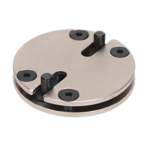 The Sealey Adjustable Brake Wind-Back Adaptor - 2-Pin (VS327) is a round metal tool featuring four black screws and two protruding metal pegs, making it ideal for vehicle applications.