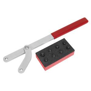 Image of the Universal Pulley & Fan Clutch Holder Set - VS4844 by Sealey, featuring a tool with a red handle and a gray, adjustable arm next to a rectangular block with several cylindrical protrusions, ideal for handling an adjustable jaw spread or working on a camshaft pulley.