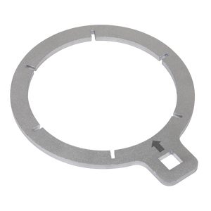 The Sealey Fuel Filter Key - Ford Transit - VS6428 is a circular metal ring featuring six evenly spaced notches and a small tab on one side with a square hole and a black arrow, designed for secure placement around the fuel filter bowl.