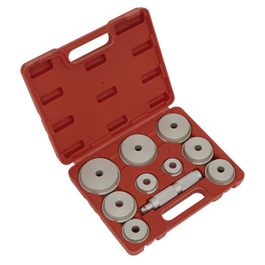 A Sealey Bearing Race & Seal Driver Set, model VS703, comes in a red plastic case with a handle and includes various popular bearing race sizes along with an assortment of circular metal dies and a central cylindrical tool, all neatly arranged in individual compartments.