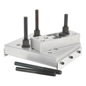 Three metal plates, each with four attached screws and two detached screws, are arranged diagonally on an aluminium base plate, forming the Universal Press Support Block (VS7036) by Sealey.