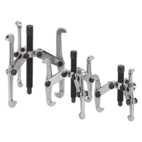The Sealey Triple Leg Gear Reversible Puller Set 3pc (VS77) is displayed, featuring three metal gear pullers of varying sizes. Each puller is equipped with three adjustable arms, a threaded center screw for extracting gears, and hex head forcing screws. They are crafted from drop-forged carbon steel and are heat-treated with a chrome-plated finish for durability.