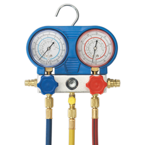 Image of the Sealey Air Conditioning System Manifold with Sight Glass - VSAC002, featuring two meters, colored knobs, and hoses. The left meter has a blue knob, and the right meter has a red knob with blue, red, and yellow hoses hanging down. Perfect for refrigerant testing in A/C systems.