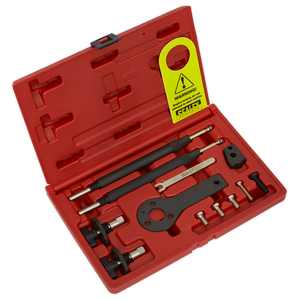 The Sealey Petrol Engine Timing Tool Kit (VSE2511A) for Alfa Romeo, Fiat, and Lancia 1.2/1.4 16v/1.4 T-Jet belt drive engines comes in a red plastic case and includes various automotive tools such as a puller, hooks, pins, and other essential components. A yellow warning tag is attached inside the case.