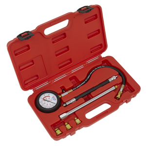 The Sealey Petrol Engine Compression Tester Deluxe Kit 6pc - VSE300D includes a red plastic case housing a 300psi pressure gauge with a flexible extension hose, three metal rods, and four brass fittings.