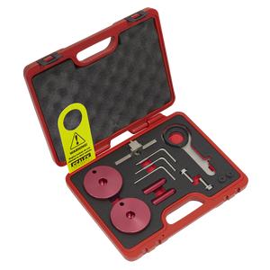 The Sealey Diesel Engine Timing Tool Kit - for Ford 2.0TDCi EcoBlue - Belt Drive (Model VSE5640) includes a red plastic carrying case with foam padding, containing assorted precision tools and components such as red discs, a wrench, and various small metal instruments crucial for diesel engine maintenance. Additionally, a caution tag is attached.