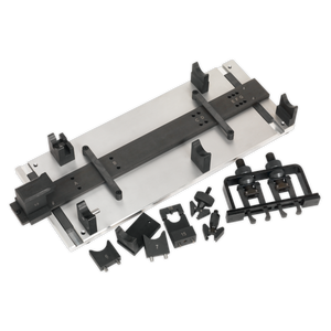 The Sealey Camshaft Installation Kit - for VAG, Porsche - Belt & Chain Drive (model VSE7171), featuring a precise arrangement of metal and plastic components with various attachments, is meticulously laid out on a surface.