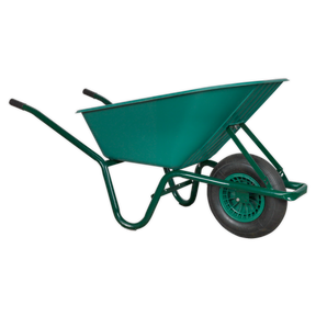 The Sealey Wheelbarrow 85L - WB85 is a green wheelbarrow with a single wheel and black handles, featuring a durable tubular steel frame for transporting materials in construction or gardening.