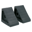 The Sealey Rubber Wheel Chocks - Pair - WC01 are two black rubber chocks designed to prevent vehicle movement. They feature a grooved surface and side holes for securing, making them perfect for ensuring vehicle incline safety.