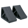 Two Sealey Rubber Wheel Chocks - Pair - WC02, featuring a black rubber construction with a grid pattern on the surface, designed to prevent vehicle movement when jacked on a level surface.