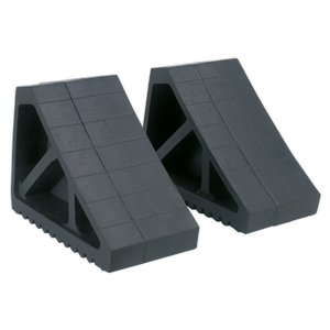 Two Sealey Rubber Wheel Chocks - Pair - WC02, featuring a black rubber construction with a grid pattern on the surface, designed to prevent vehicle movement when jacked on a level surface.