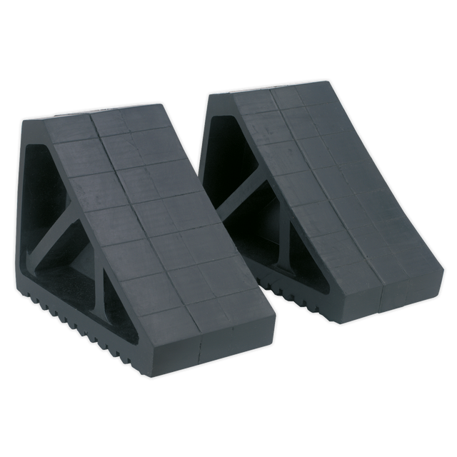 Two Sealey Rubber Wheel Chocks - Pair - WC02, featuring a black rubber construction with a grid pattern on the surface, designed to prevent vehicle movement when jacked on a level surface.