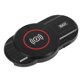 The Wireless Charging Base Single 5V⎓1A - WCB3 by Sealey is a black wireless charging pad featuring a circular charging area highlighted by a red and white circle, making it perfect for use as a wireless charging base. The brand name "Sealey" is prominently displayed in the upper right section.