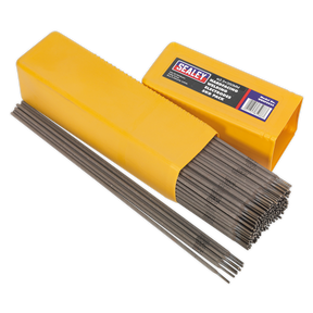 A yellow box of Sealey Welding Electrodes Hardfacing Ø2.5 x 300mm 5kg Pack - WEHF5025 is open, revealing several electrodes neatly packed inside and some laid out beside the box—ideal for repairs on agricultural and construction machinery.