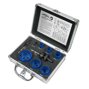 An open metal case from Sealey contains the Hole Saw Kit 9pc - Plumbers - WSPHSK, featuring various blue bi-metal blades, arbors, a drill bit, and an instruction sheet inside the lid.