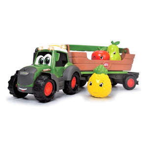 The AGCO Fendti Fruit Trailer - X991022003000 features a Fendt toy tractor with a smiling face, pulling a trailer filled with rattle fruits, including a red apple, green pear, and yellow pineapple, all adorned with cartoon faces.