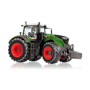 The AGCO Fendt 1050 Vario update (1:32) - X991022006000 is a collector's model tractor, featuring a green and black design with large red wheels. The tractor is viewed from an angle and isolated on a white background, showcasing its detailed craftsmanship at a 1:32 scale.